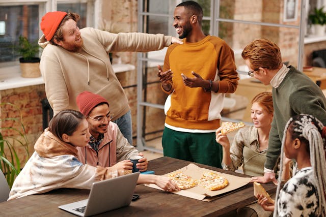 Group of people around a table talking and laughing